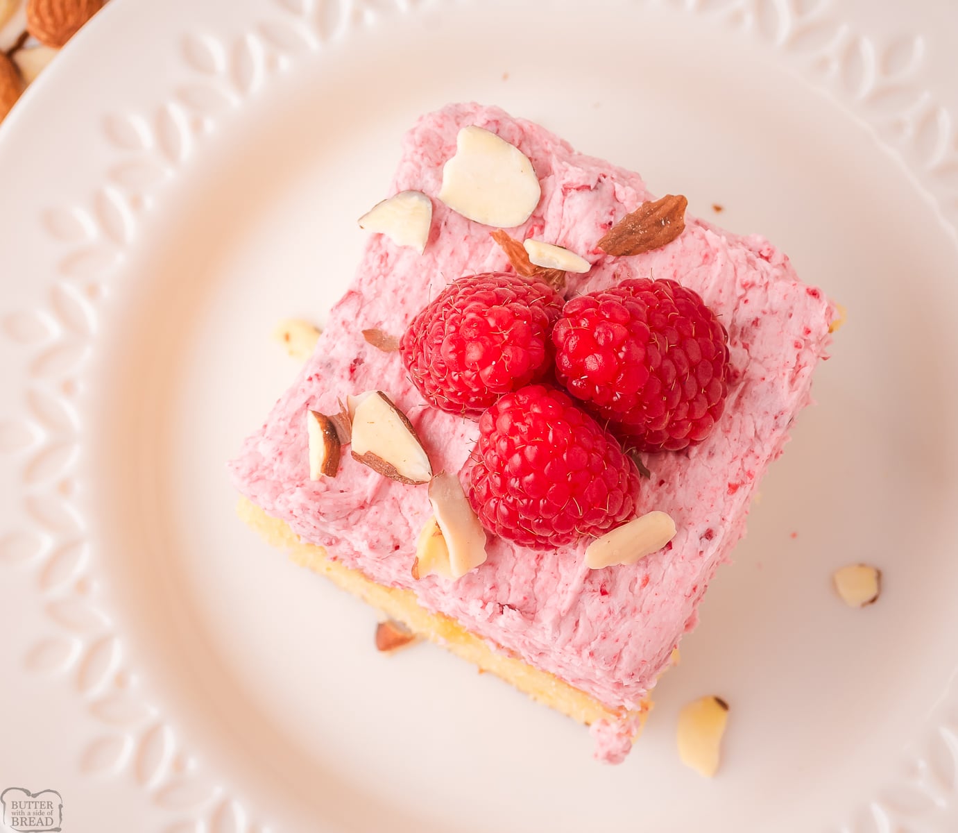 raspberry almond cake topped with fresh raspberries